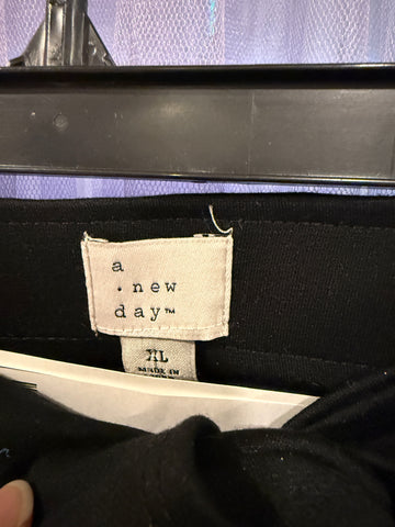 A New Day brand label and XL size label with loose thread near the label