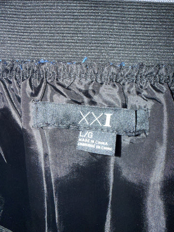 Detail of blue and black abstract pattern and skirt hem