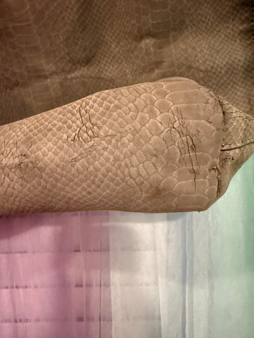 Close-up showing pronounced cracking and peeling on bag bottom and corner