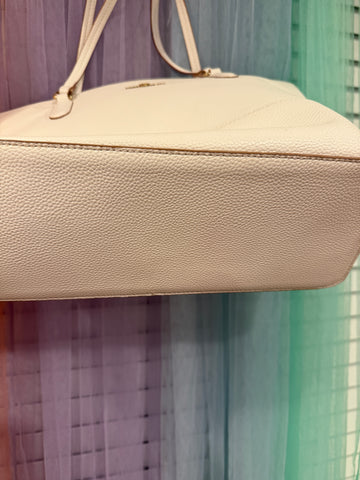 Close-up of textured ivory tote base showing small surface marks