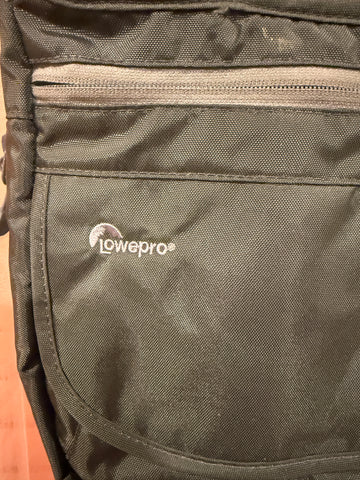 Close-up of embroidered Lowepro logo and contrasting front zipper