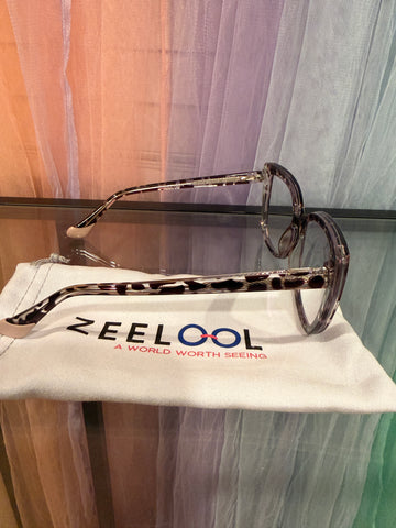 Side view showing patterned eyeglass arms and pale temple tips