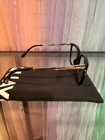 Side view showing gold-tone arms and black temple tips
