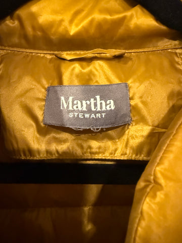 Close-up of Martha Stewart brand label inside gold quilted jacket